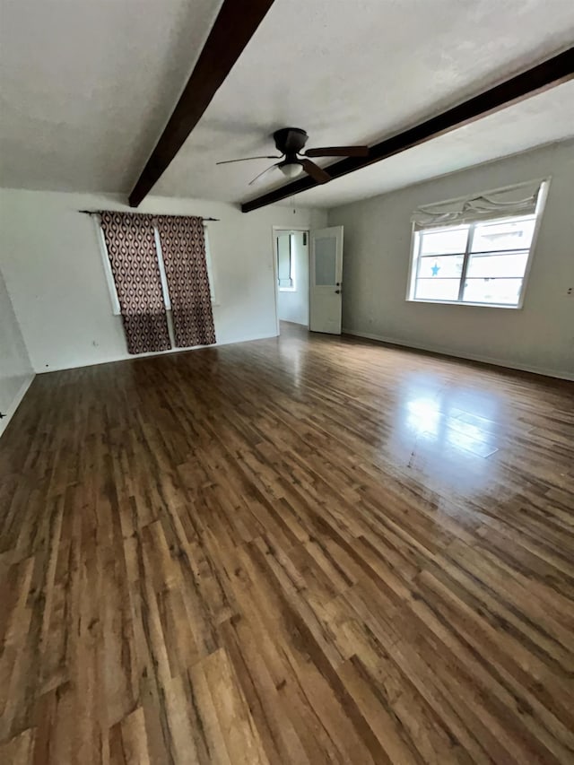 unfurnished living room with beam ceiling, ceiling fan, and wood-type flooring