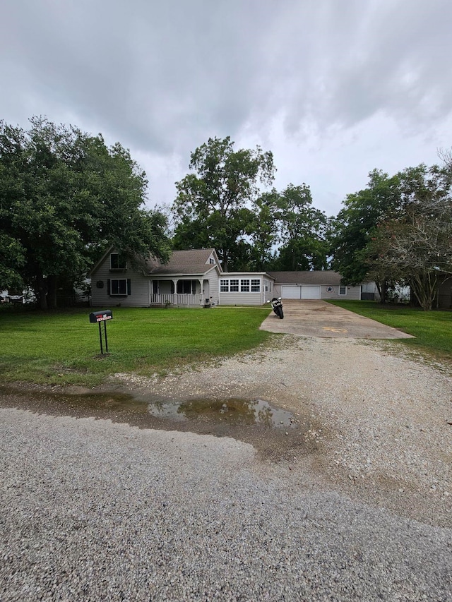 view of front of house with a front yard and a garage