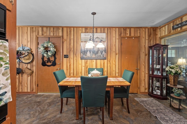 2836 Old Spurger Rd, Silsbee, TX 77656 - dining area featuring wooden walls and a chandelier
