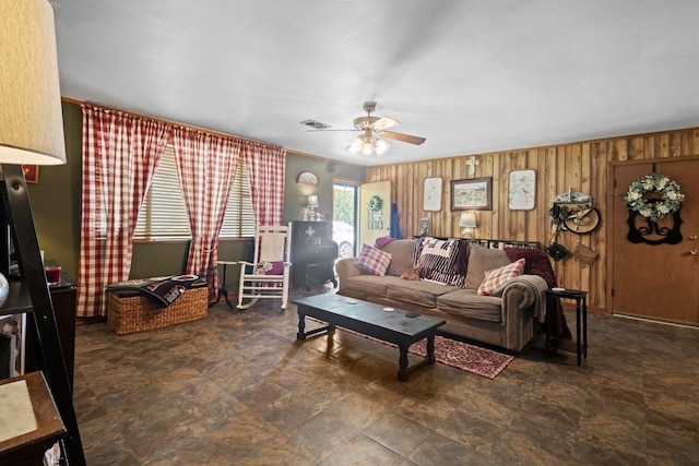 2836 Old Spurger Rd, Silsbee, TX 77656 - living room featuring ceiling fan and wood walls