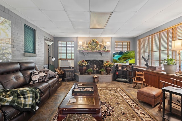 2836 Old Spurger Rd, Silsbee, TX 77656 - living room with cooling unit, brick wall, a paneled ceiling, and a fireplace