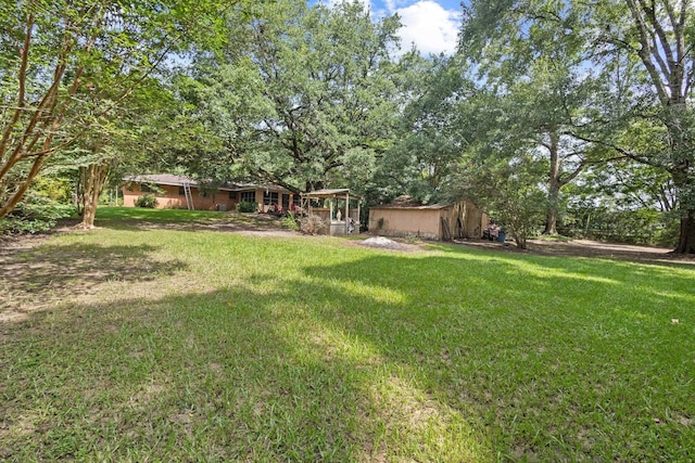 2836 Old Spurger Rd, Silsbee, TX 77656 - view of grassy yard with an outdoor structure