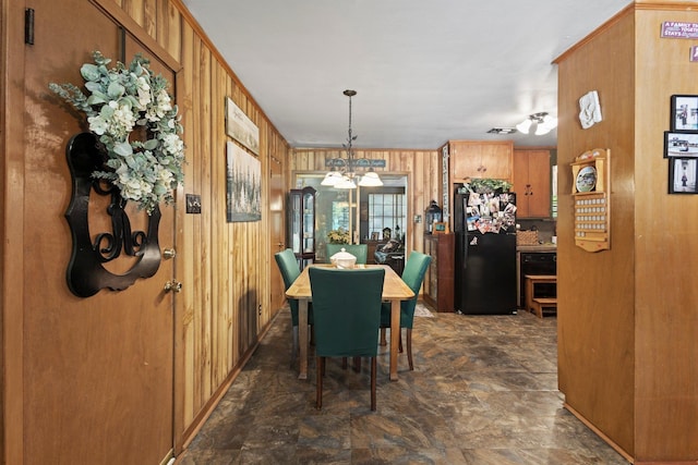2836 Old Spurger Rd, Silsbee, TX 77656 - dining room with wooden walls, a chandelier, and stone finish floors
