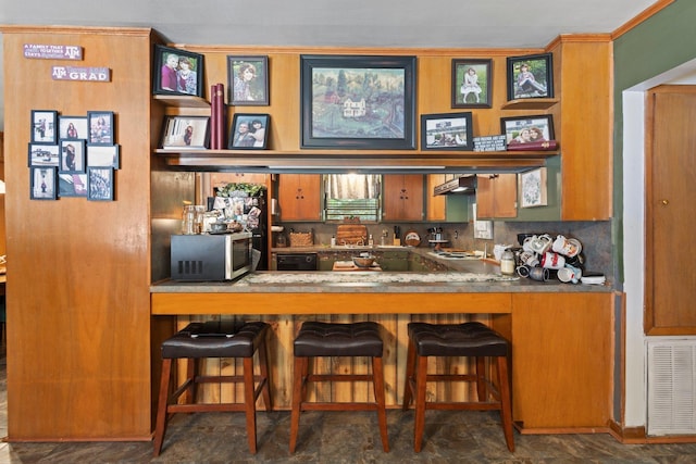 2836 Old Spurger Rd, Silsbee, TX 77656 - bar featuring stainless steel microwave, range hood, black dishwasher, and stovetop