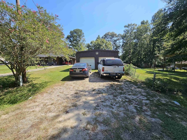 view of front of house with a garage, a front lawn, and an outdoor structure