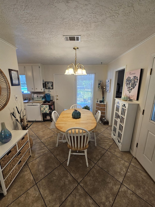 tiled dining room with plenty of natural light, a textured ceiling, and a notable chandelier