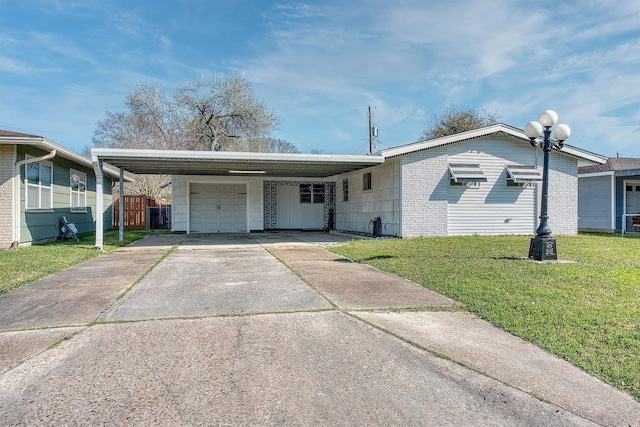 ranch-style home with a front yard, concrete driveway, a carport, and a garage