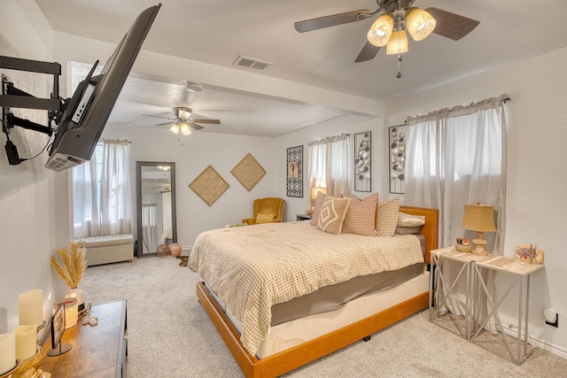 bedroom with baseboards, light colored carpet, visible vents, and ceiling fan