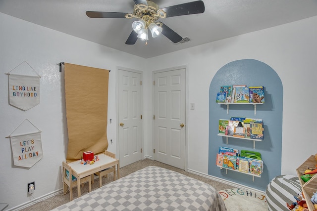 rec room with visible vents, carpet floors, baseboards, and ceiling fan