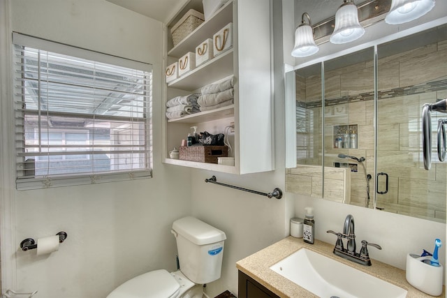 full bathroom with a shower stall, toilet, and vanity