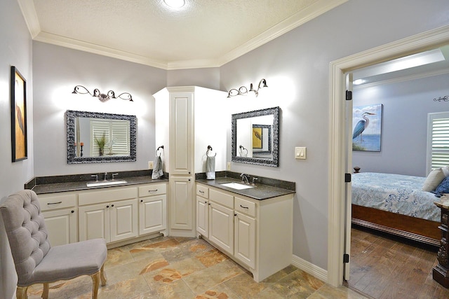 full bathroom with two vanities, crown molding, connected bathroom, and a sink