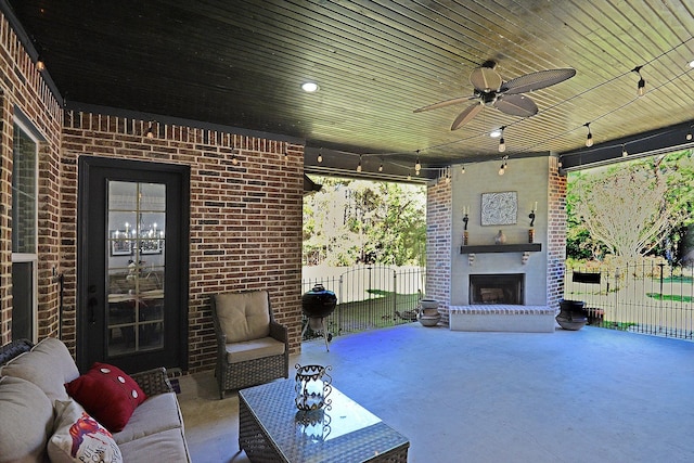 view of patio / terrace featuring an outdoor living space with a fireplace, ceiling fan, and fence