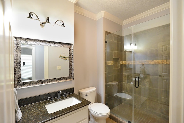 full bath with toilet, a stall shower, a textured ceiling, crown molding, and vanity