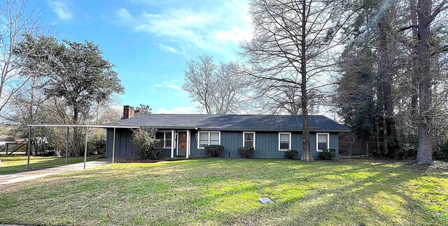 ranch-style house featuring a chimney, concrete driveway, a front yard, fence, and an attached carport