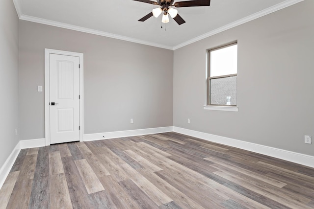 spare room with crown molding, ceiling fan, and light wood-type flooring