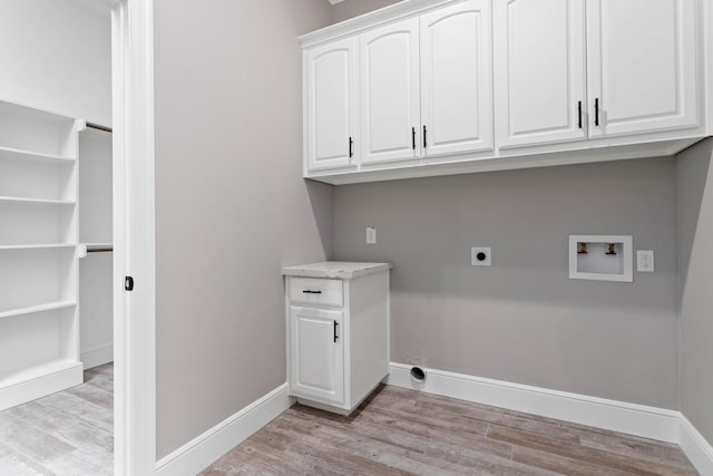 washroom with washer hookup, cabinets, light hardwood / wood-style floors, and electric dryer hookup