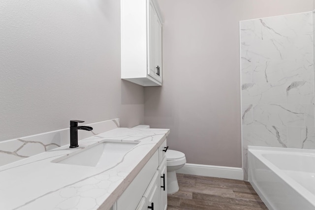 bathroom featuring vanity, hardwood / wood-style flooring, and toilet