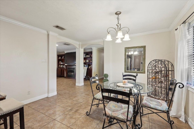 dining area with baseboards, visible vents, arched walkways, ornamental molding, and light tile patterned flooring