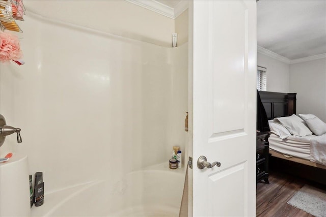 full bathroom featuring a shower, crown molding, and wood finished floors