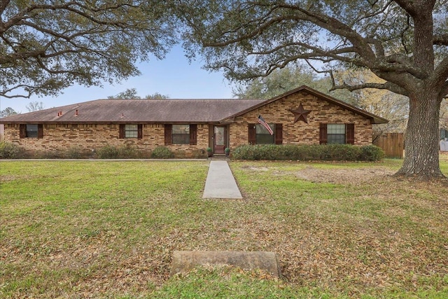 ranch-style house featuring a front yard, brick siding, and fence