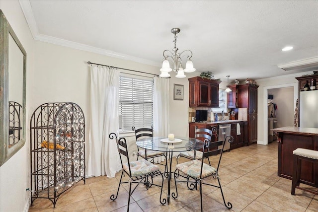 dining room with a chandelier, light tile patterned flooring, and ornamental molding