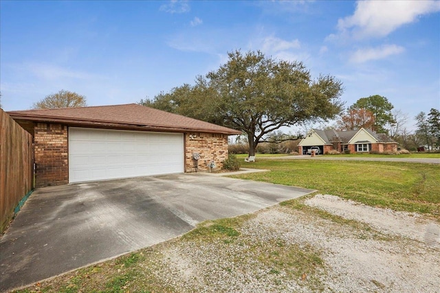 view of home's exterior with driveway, a garage, a lawn, and brick siding