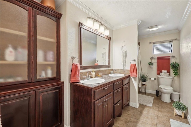 full bathroom with toilet, ornamental molding, a sink, and tile patterned floors