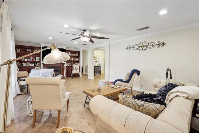 living room featuring light tile patterned floors, visible vents, arched walkways, crown molding, and recessed lighting