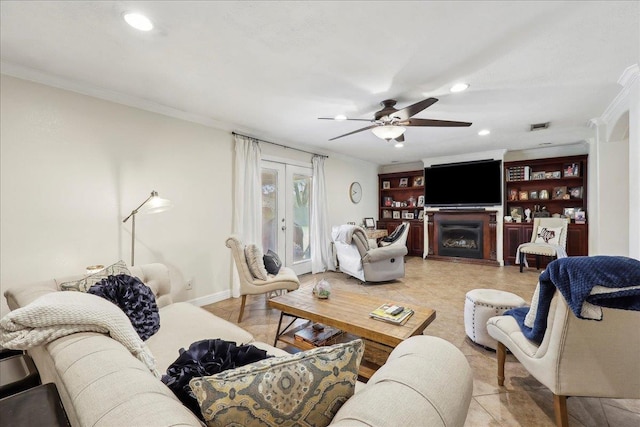 living area featuring recessed lighting, a fireplace, ornamental molding, and french doors