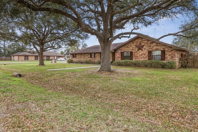 single story home with brick siding and a front lawn