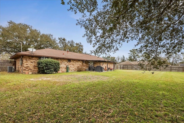 view of yard featuring central AC unit and a fenced backyard