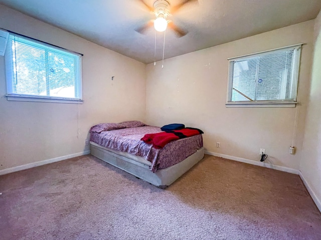 bedroom with ceiling fan and light carpet