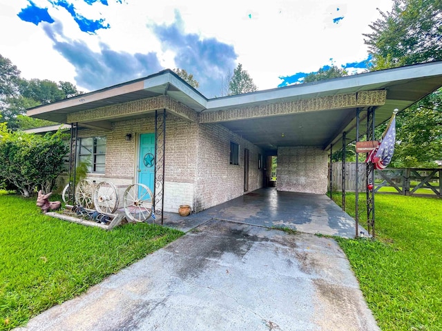 view of front of property with a front lawn and a carport