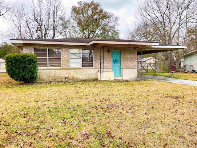 ranch-style home with a carport and a front yard