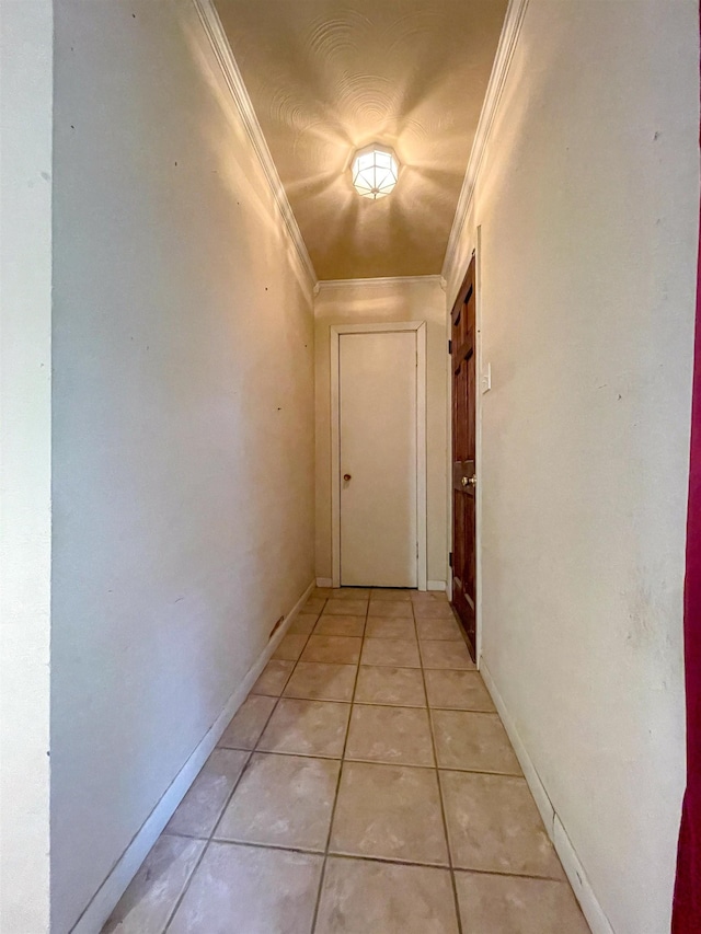 hallway featuring light tile patterned flooring and ornamental molding