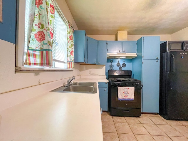 kitchen with light tile patterned flooring, sink, blue cabinets, and black appliances