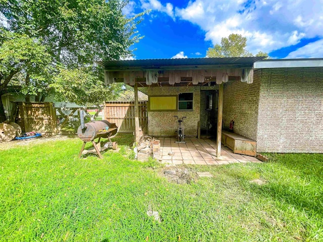 back of property with a yard and a patio