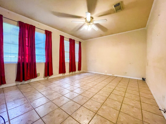 spare room featuring light tile patterned flooring, ceiling fan, and ornamental molding