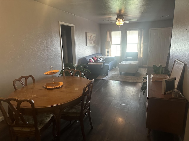 3104 Main Ave, Groves, TX 77619 - dining area with a textured wall, dark wood finished floors, ceiling fan, and a textured ceiling