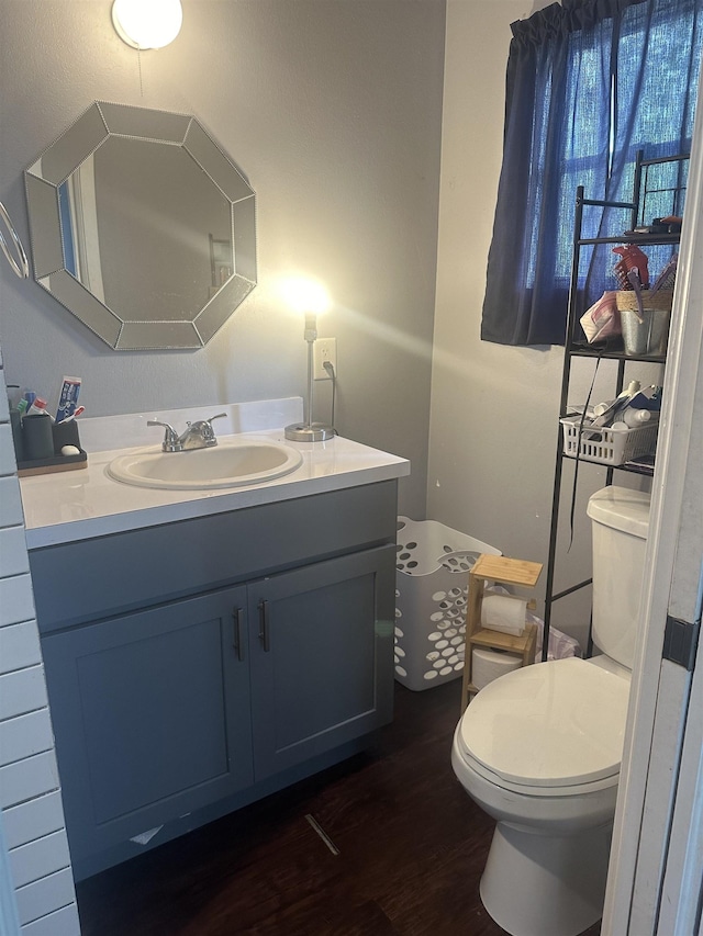 3104 Main Ave, Groves, TX 77619 - bathroom featuring wood finished floors, toilet, and vanity