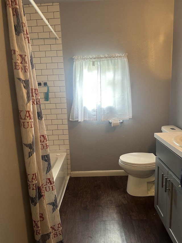 3104 Main Ave, Groves, TX 77619 - bathroom featuring wood finished floors, toilet, vanity, baseboards, and shower / bath combo