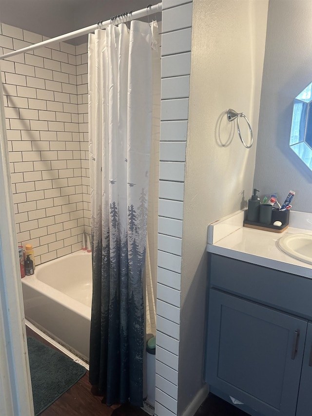 3104 Main Ave, Groves, TX 77619 - bathroom featuring shower / tub combo with curtain, vanity, and wood finished floors