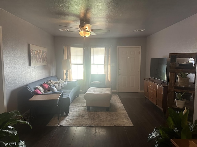 3104 Main Ave, Groves, TX 77619 - living area with dark wood-style floors, a ceiling fan, and a textured ceiling