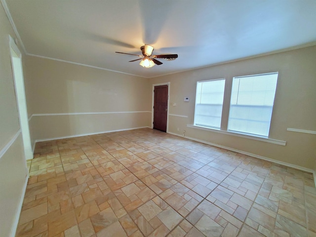 unfurnished room with ceiling fan and ornamental molding