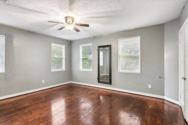 empty room featuring hardwood / wood-style floors, ceiling fan, and a textured ceiling