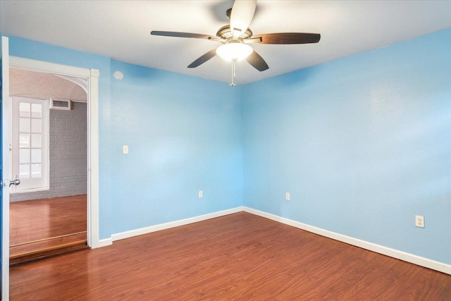 unfurnished room with ceiling fan, hardwood / wood-style floors, and french doors