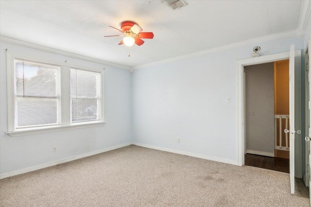 carpeted empty room featuring ceiling fan and ornamental molding