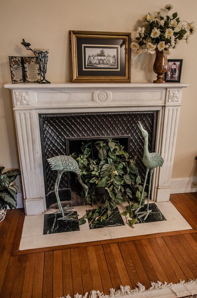 interior details featuring a premium fireplace and hardwood / wood-style flooring