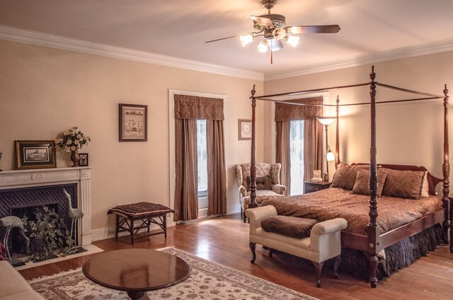 bedroom featuring ceiling fan, wood-type flooring, and ornamental molding