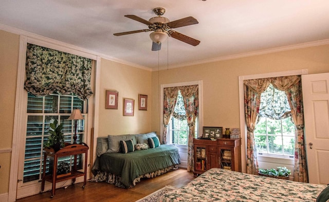 bedroom with hardwood / wood-style flooring, ceiling fan, and crown molding